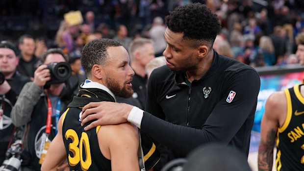 Milwaukee Bucks forward Giannis Antetokounmpo (34) and Golden State Warriors guard Stephen Curry (30)